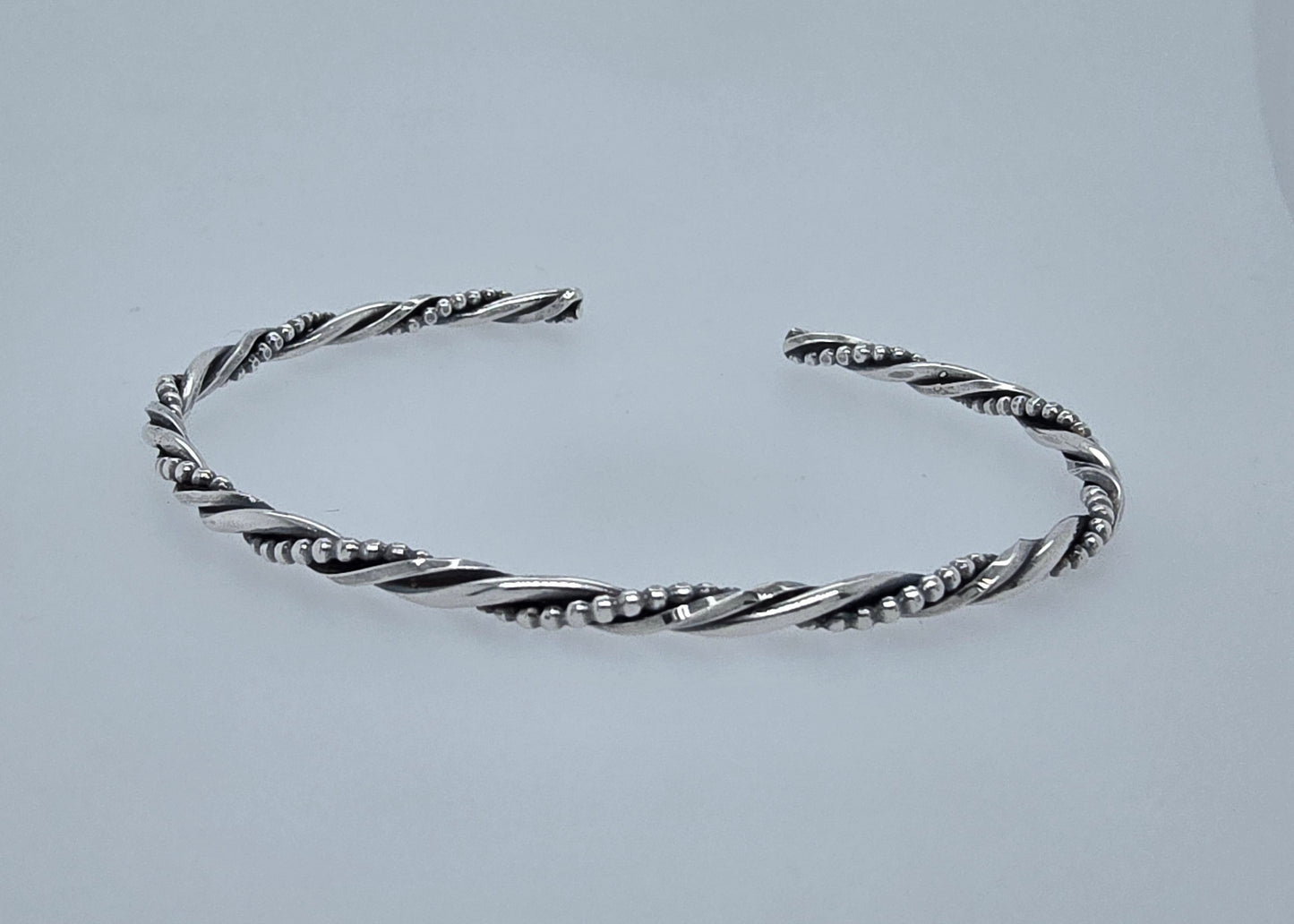 Zilveren armband gedraaid.